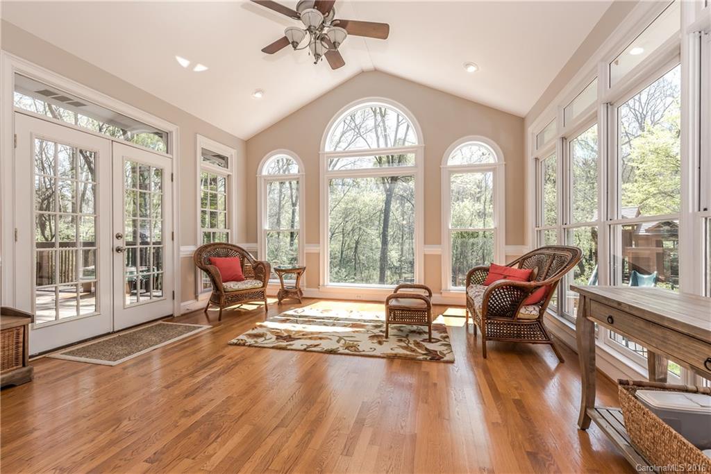 1644 Windy Ridge Road Charlotte, NC 28270 - Photo 8 of 24 a living room filled with furniture and floor to ceiling windows