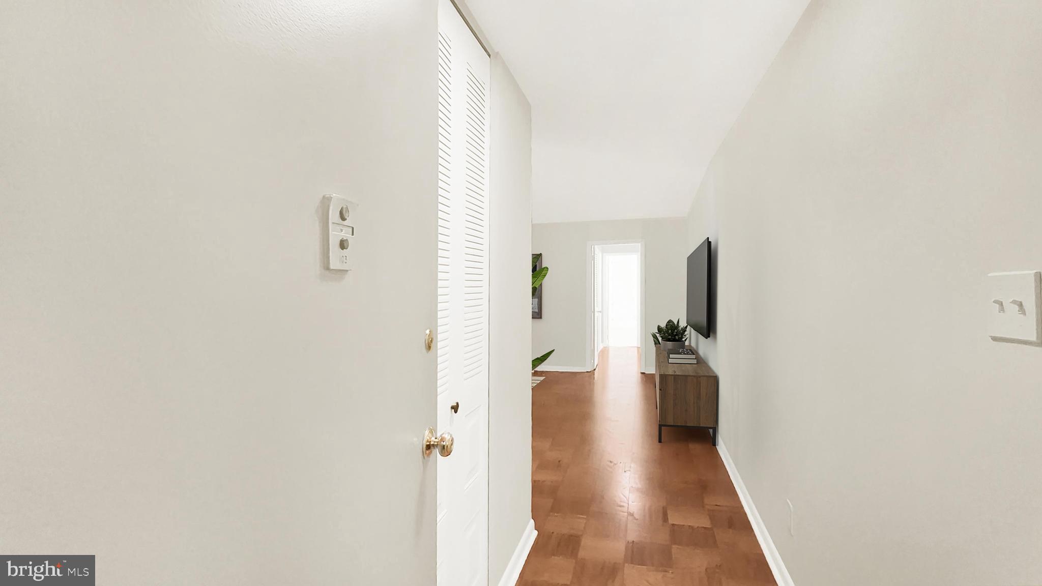 10655 Montrose Avenue, Unit 103 Bethesda, MD 20814 - Photo 12 of 26 a view of a hallway with wooden floor
