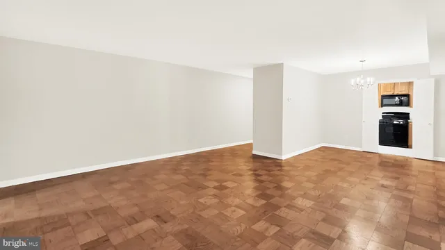 a view of a livingroom with wooden floor and a staircase