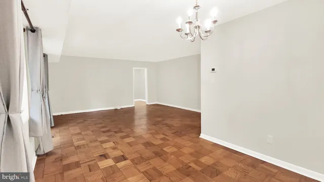 a view of a chandelier fan and entryway