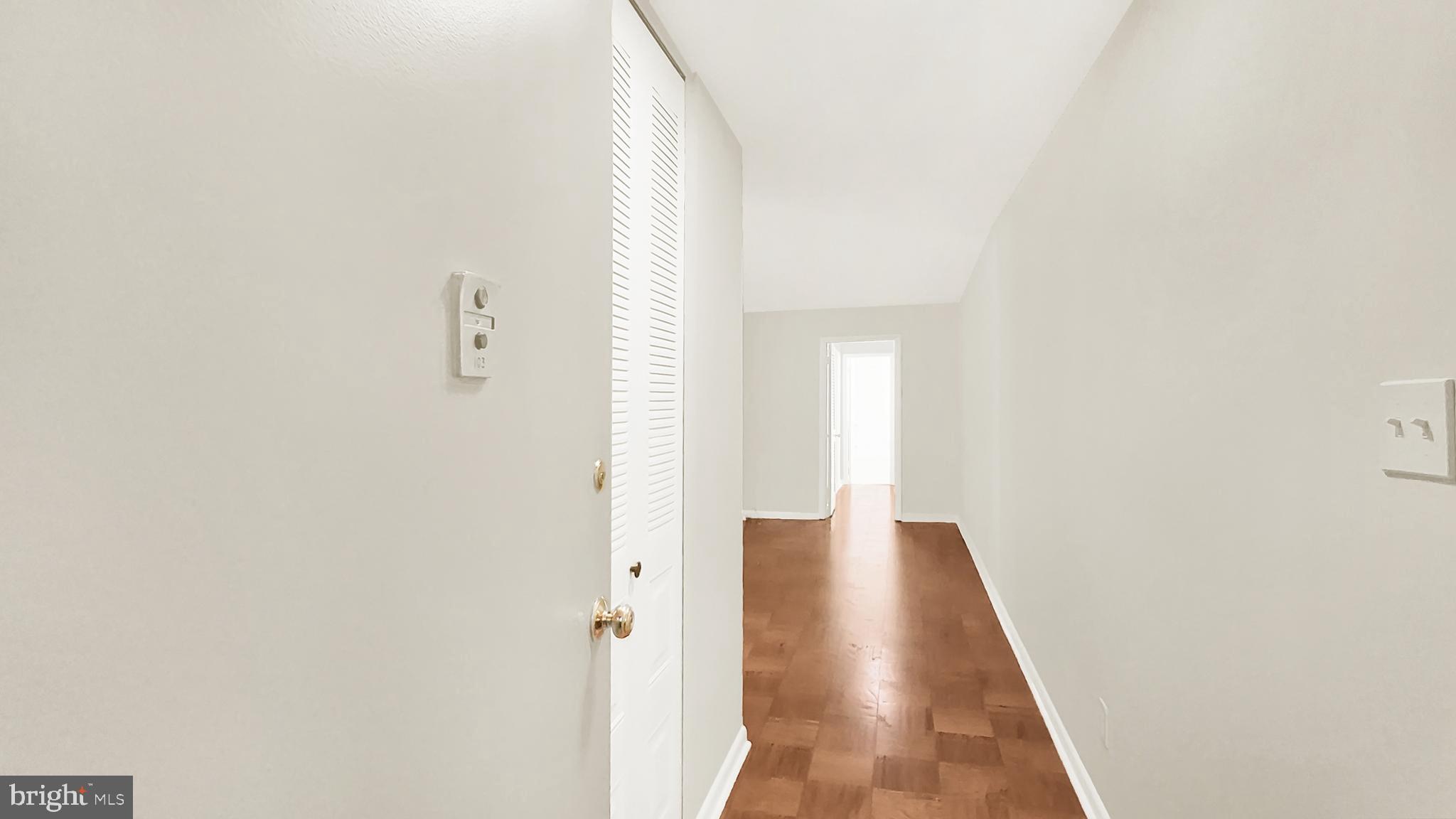 10655 Montrose Avenue, Unit 103 Bethesda, MD 20814 - Photo 22 of 26 a view of a hallway with wooden floor