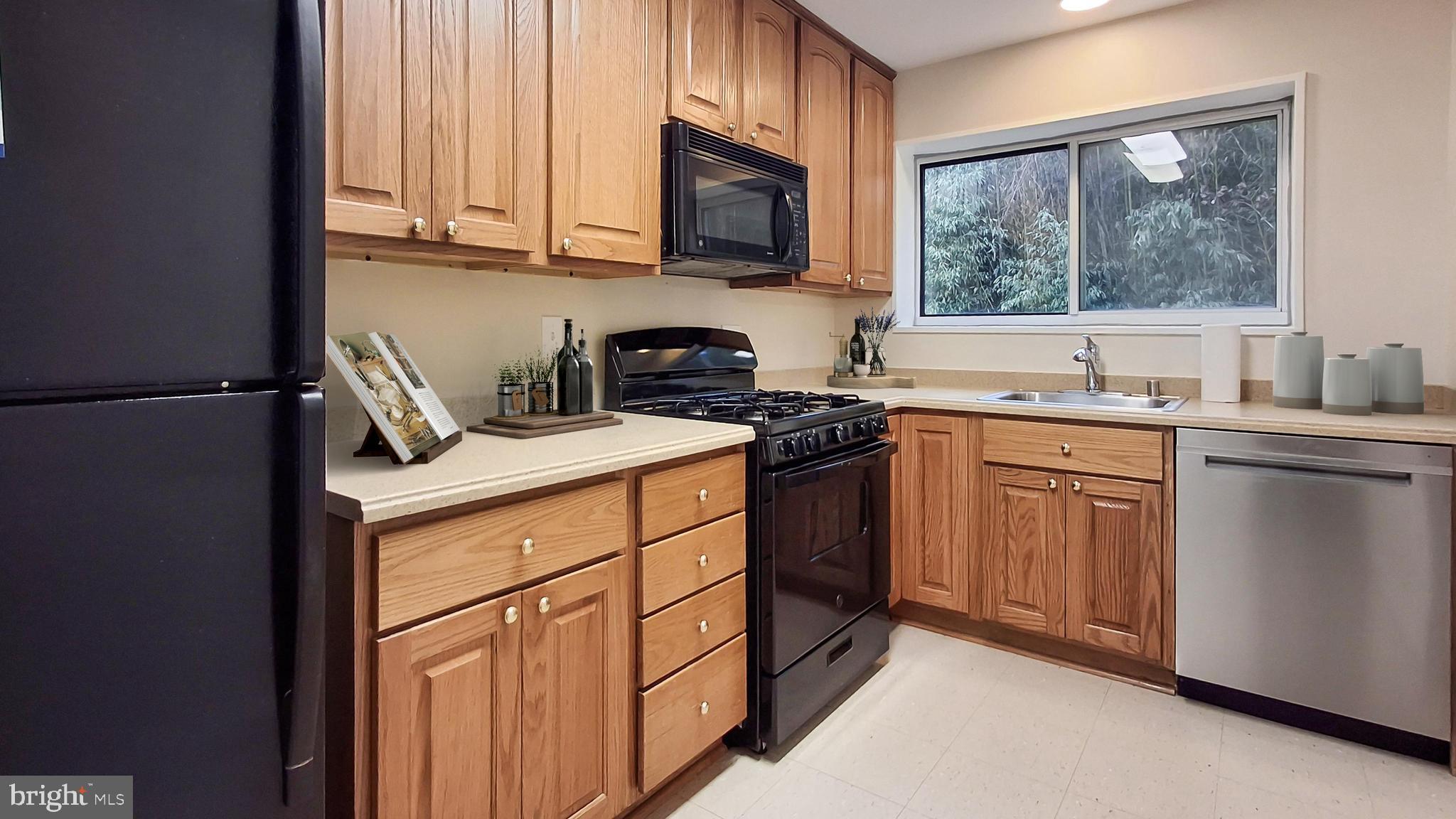 10655 Montrose Avenue, Unit 103 Bethesda, MD 20814 - Photo 4 of 26 a kitchen with stainless steel appliances granite countertop a sink stove refrigerator and microwave