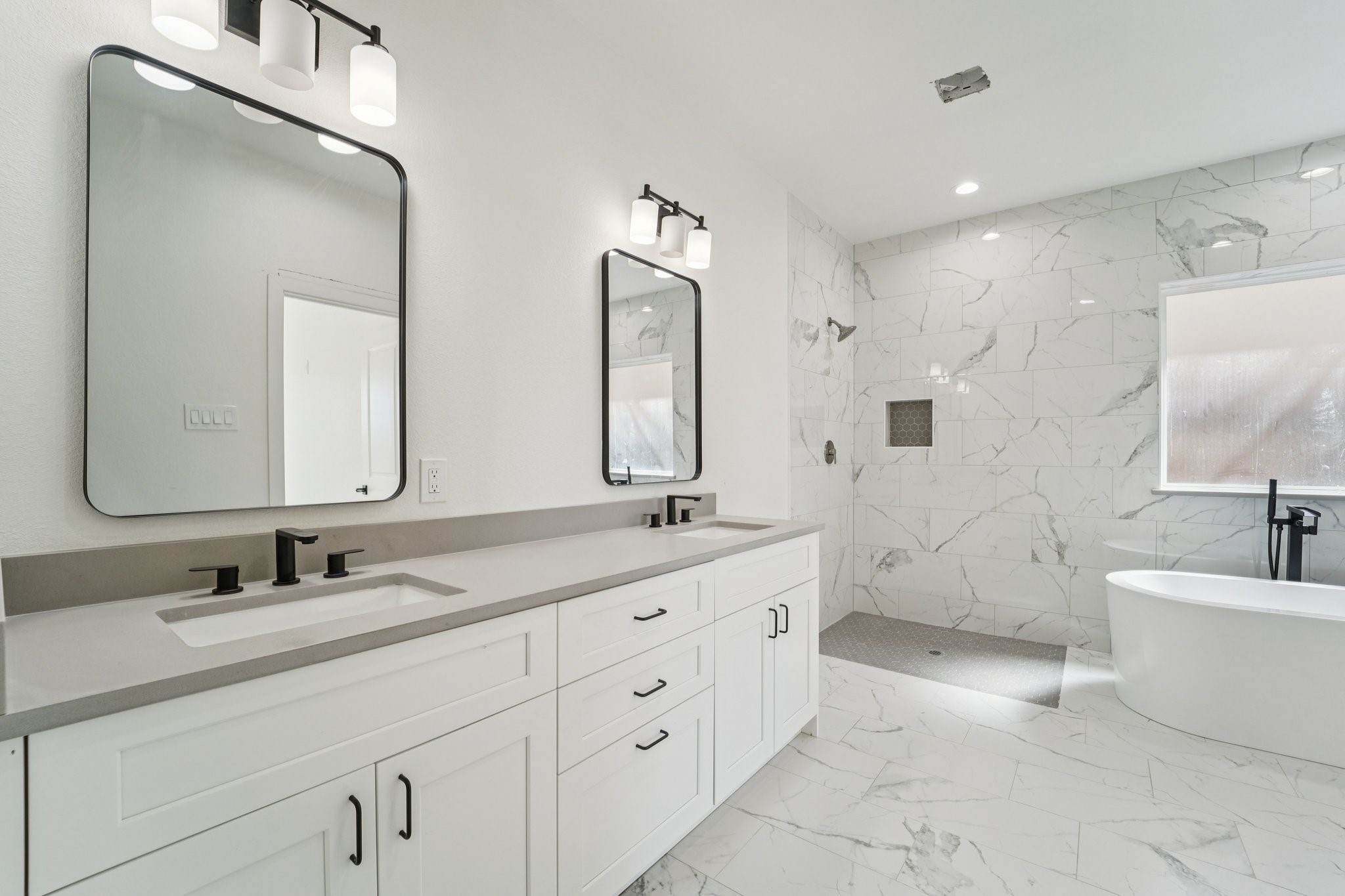 708 South Carroll Street La Porte, TX 77571 - Photo 16 of 29 a bathroom with double vanity sinks double vanity tub and a mirror