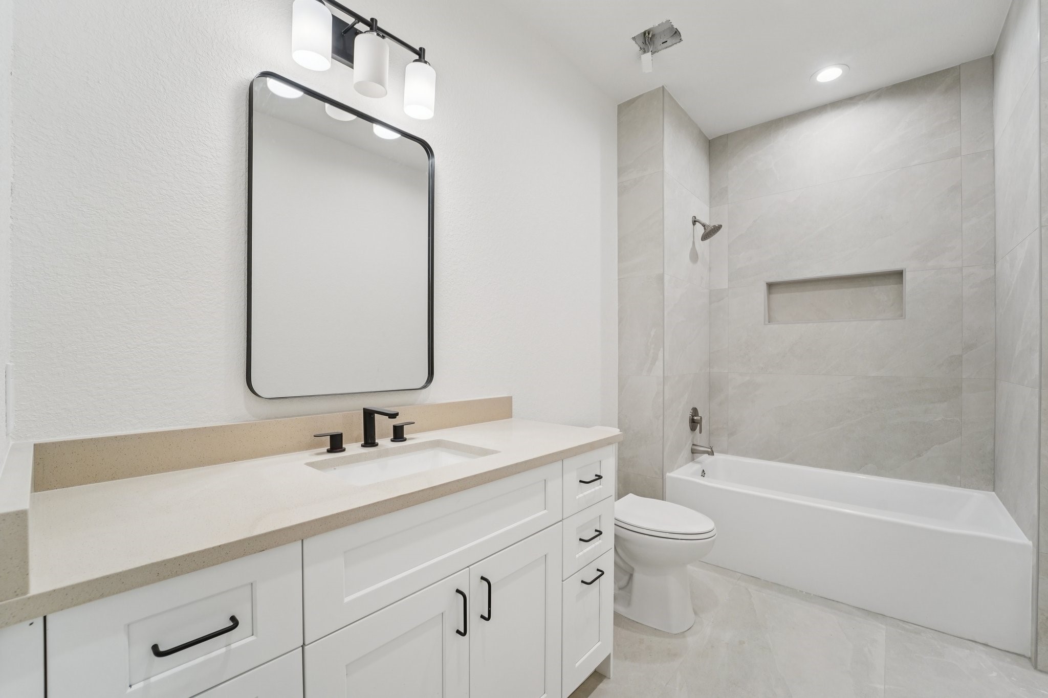 708 South Carroll Street La Porte, TX 77571 - Photo 20 of 29 a bathroom with a double vanity sink toilet mirror and bathtub