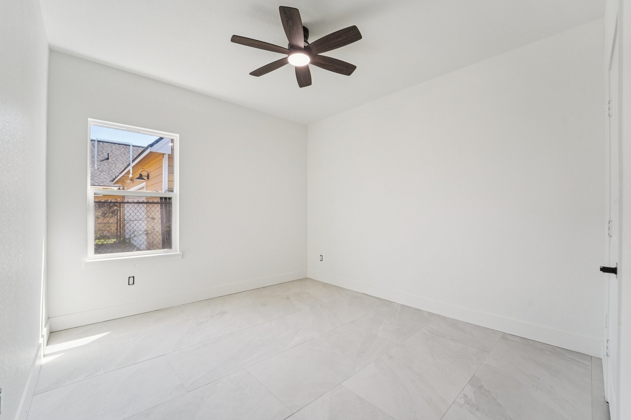 708 South Carroll Street La Porte, TX 77571 - Photo 21 of 29 an empty room with a ceiling fan and a window