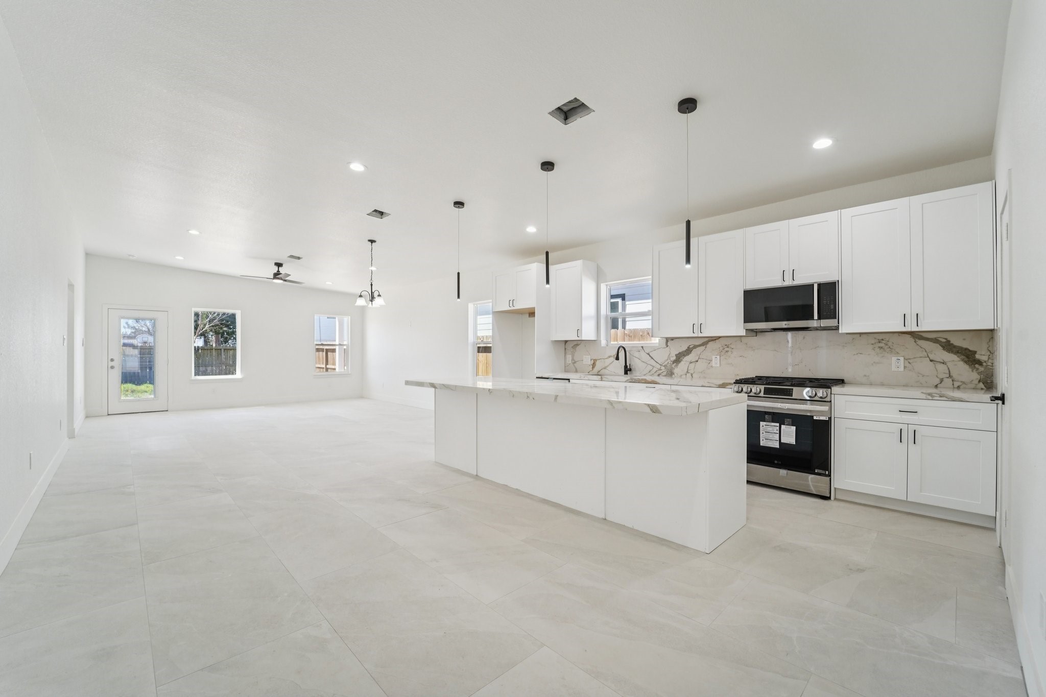 708 South Carroll Street La Porte, TX 77571 - Photo 5 of 29 a large white kitchen with stainless steel appliances granite countertop a stove and a sink
