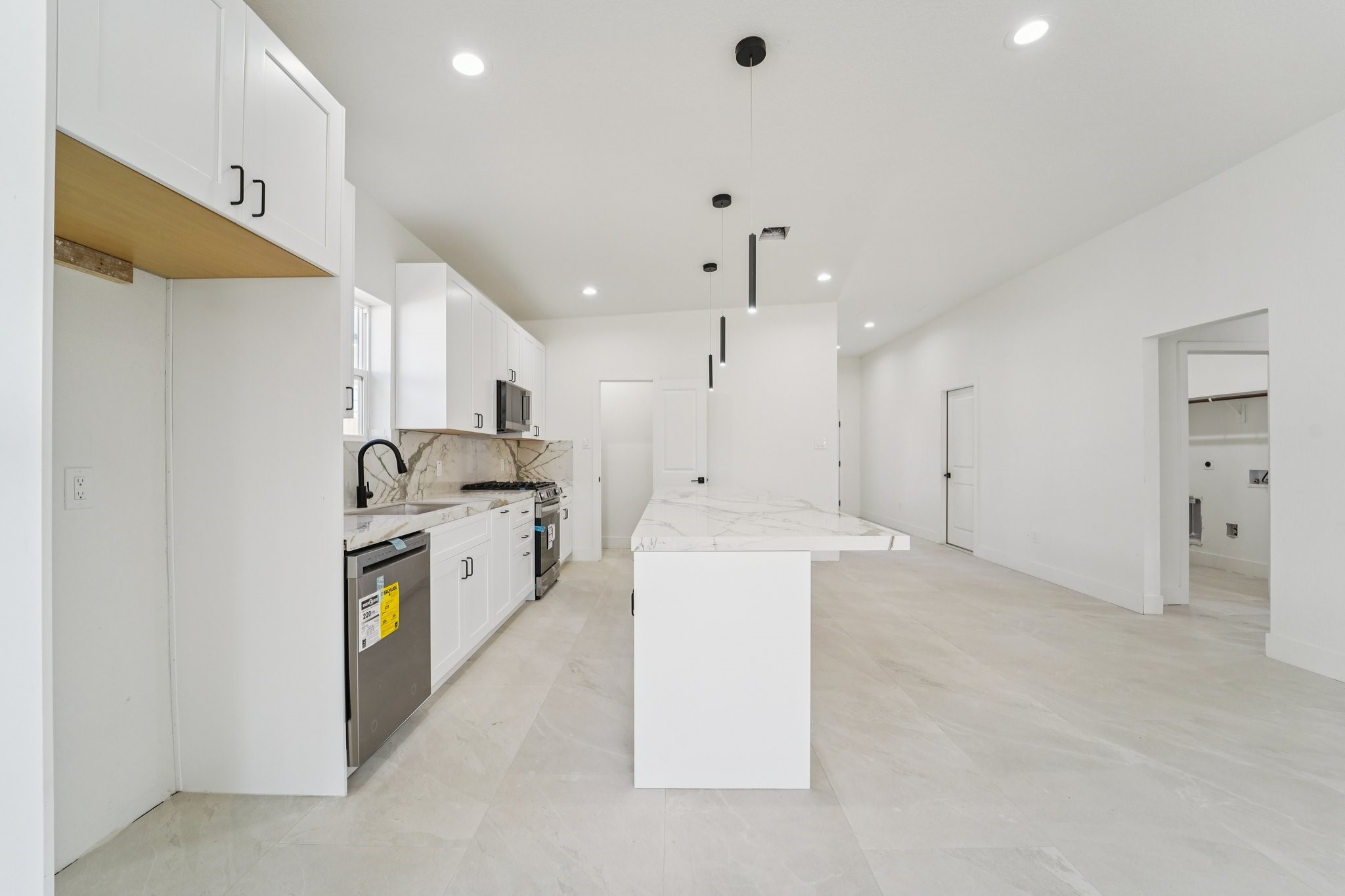 708 South Carroll Street La Porte, TX 77571 - Photo 8 of 29 a kitchen with a sink a stove a refrigerator and a window