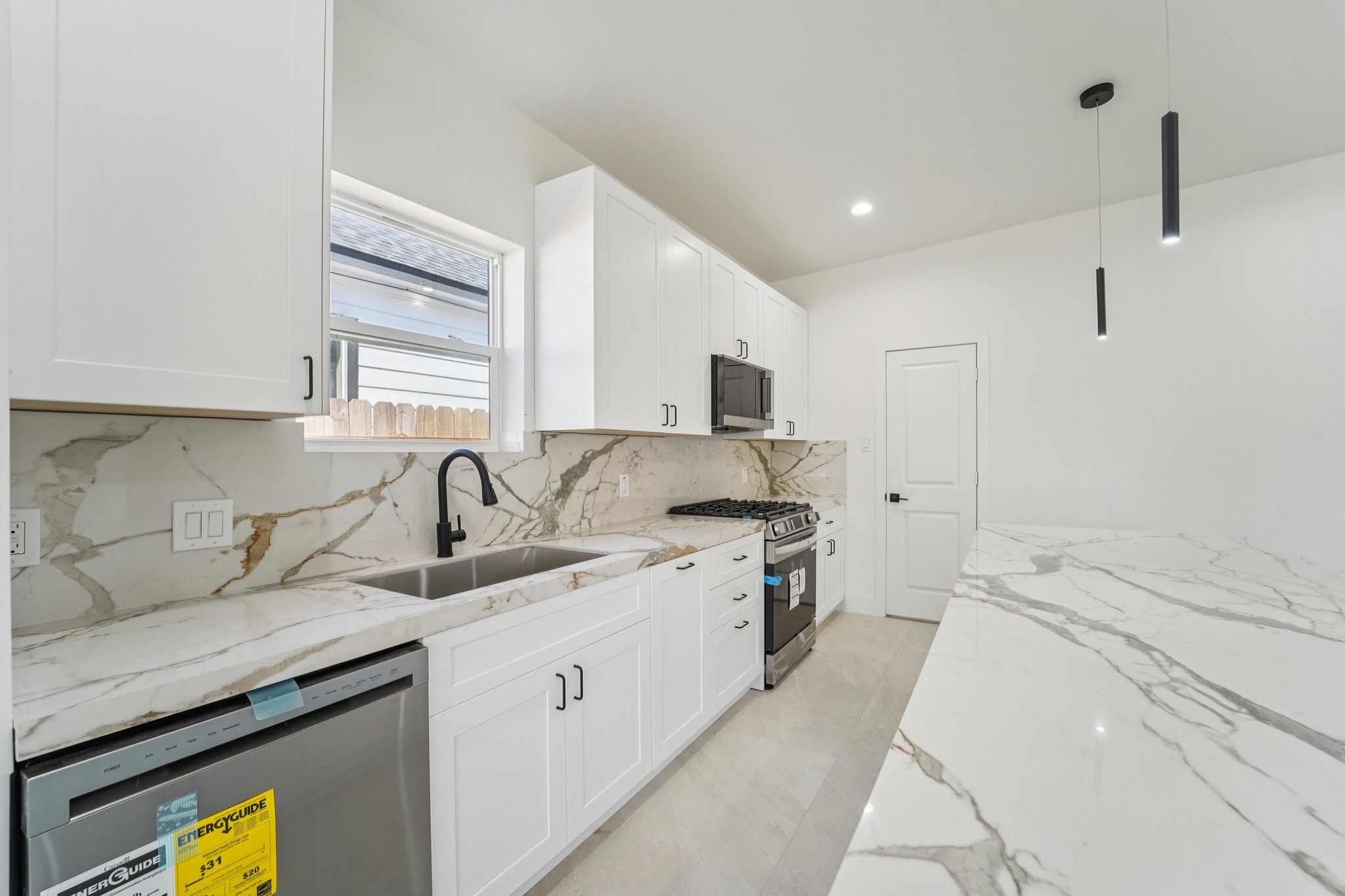 708 South Carroll Street La Porte, TX 77571 - Photo 9 of 29 a kitchen with a sink stove top oven and cabinets
