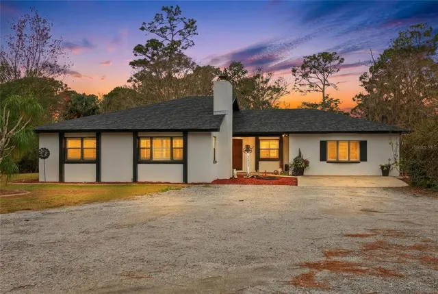 a view of large house with a yard and garage