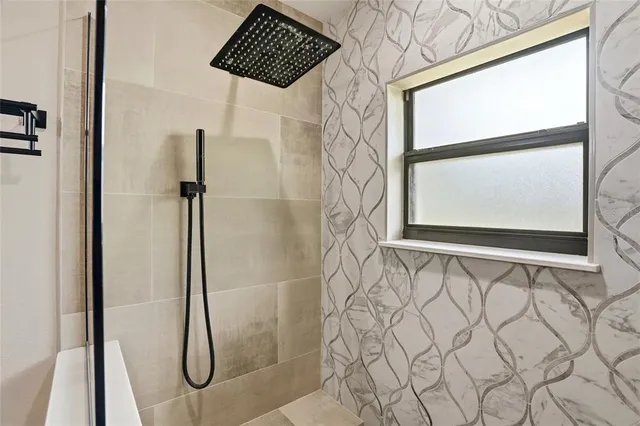 a bathroom with a shower and a sink