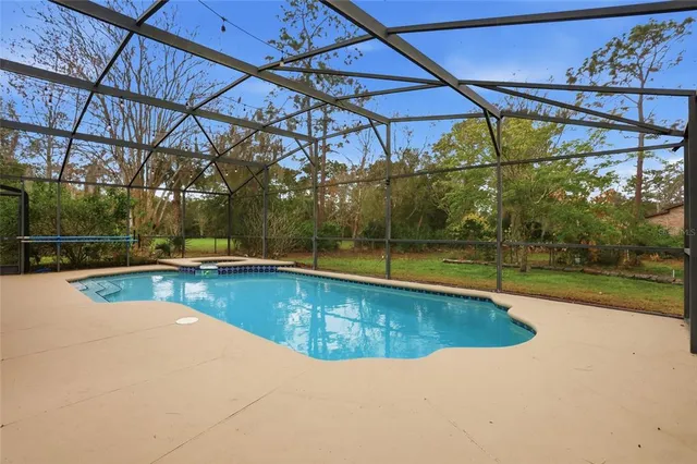a view of a swimming pool with a yard