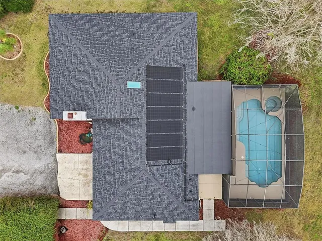 an aerial view of a house with outdoor space