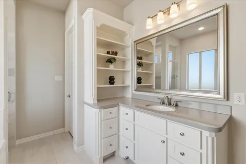 a bathroom with a sink a vanity and a mirror