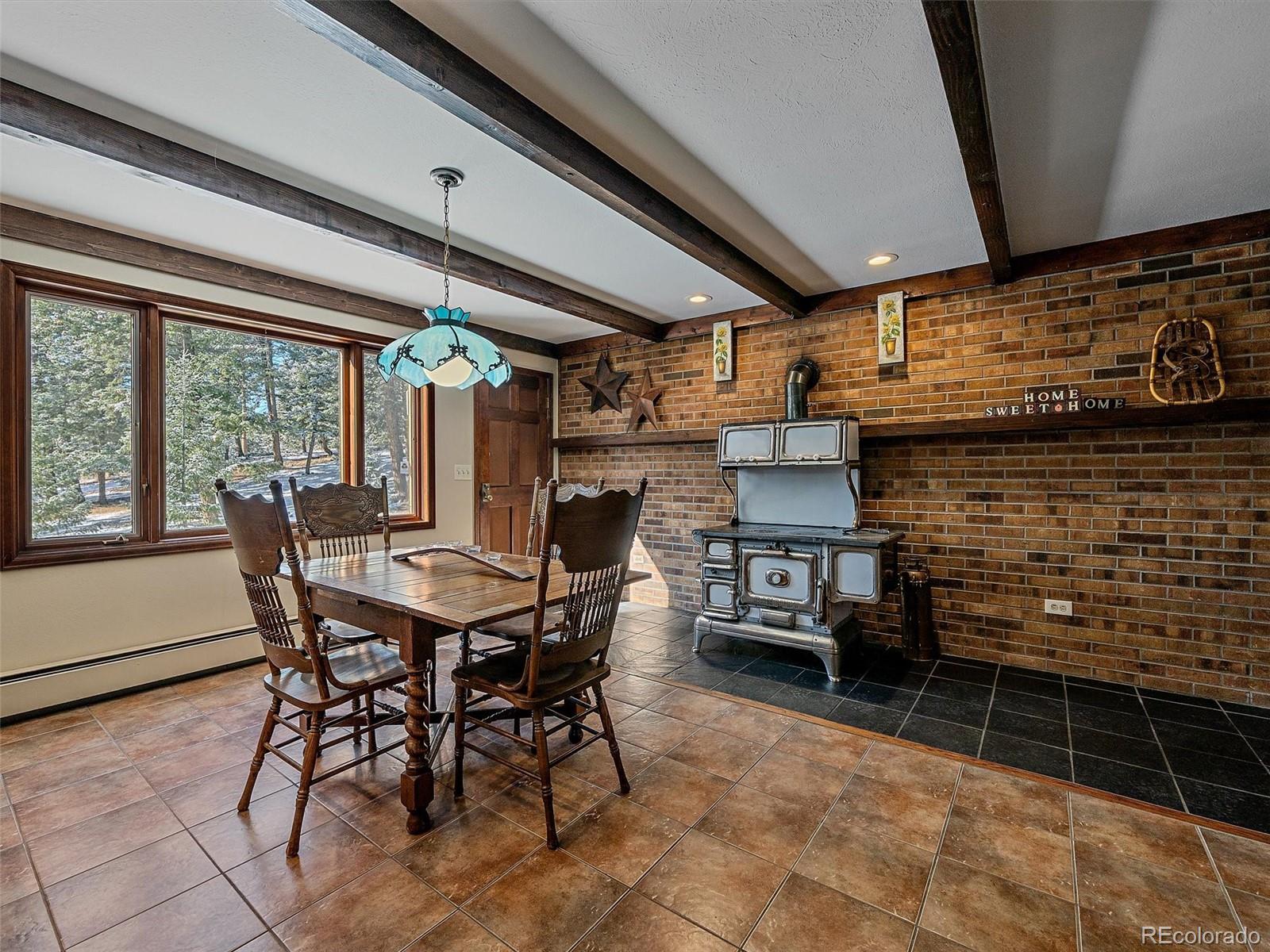 7990 Tim Tam Trail Evergreen, CO 80439 - Photo 11 of 45 a view of a dining room with furniture window and outside view