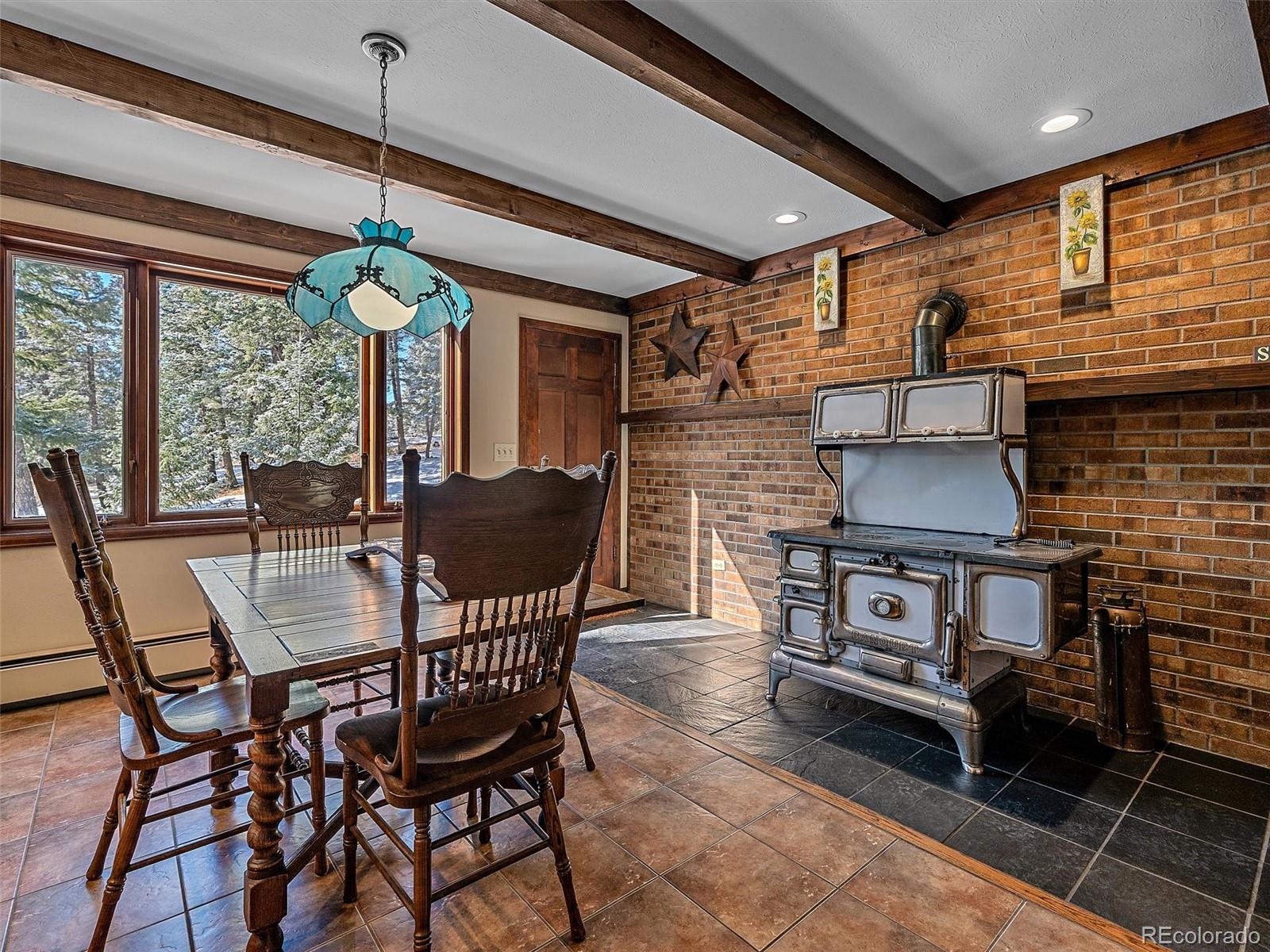 7990 Tim Tam Trail Evergreen, CO 80439 - Photo 12 of 45 a dining room with furniture and window