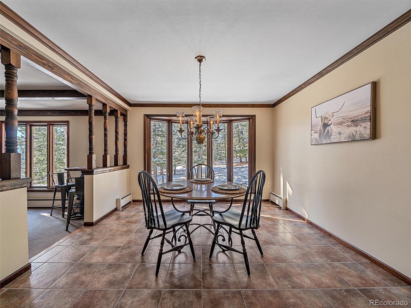 7990 Tim Tam Trail Evergreen, CO 80439 - Photo 13 of 45 a view of a dining room with furniture window and outside view