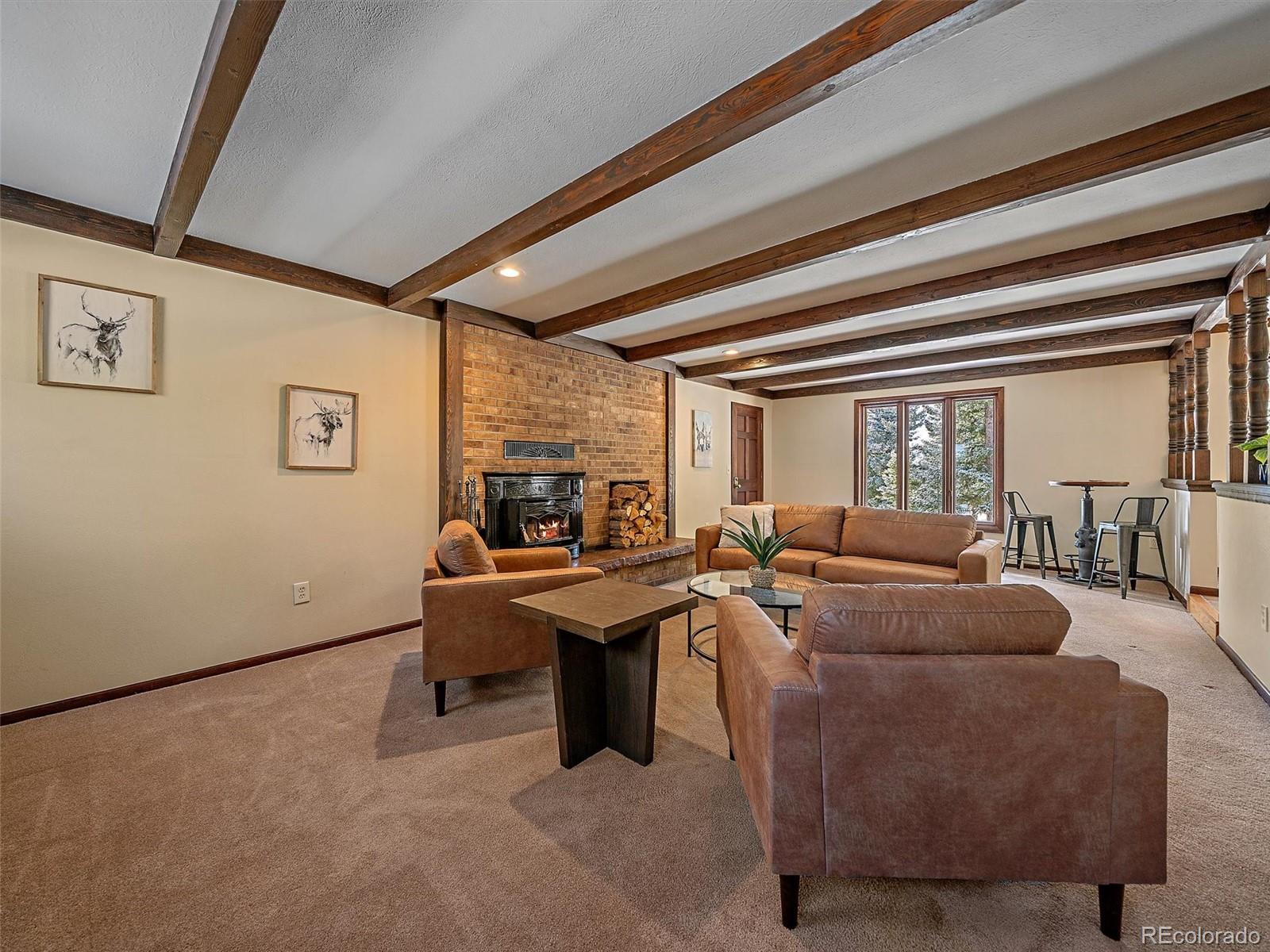 7990 Tim Tam Trail Evergreen, CO 80439 - Photo 14 of 45 a living room with furniture and a large window
