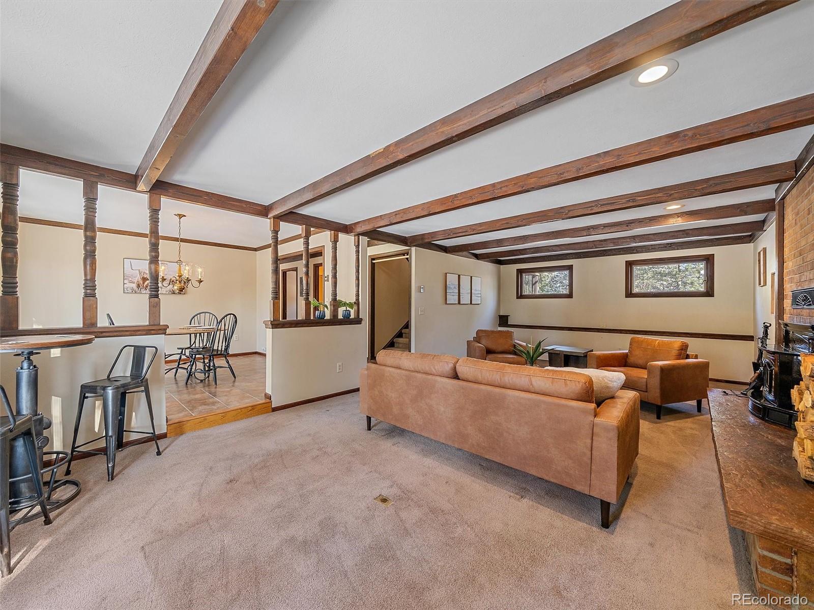 7990 Tim Tam Trail Evergreen, CO 80439 - Photo 17 of 45 a living room with furniture and a window