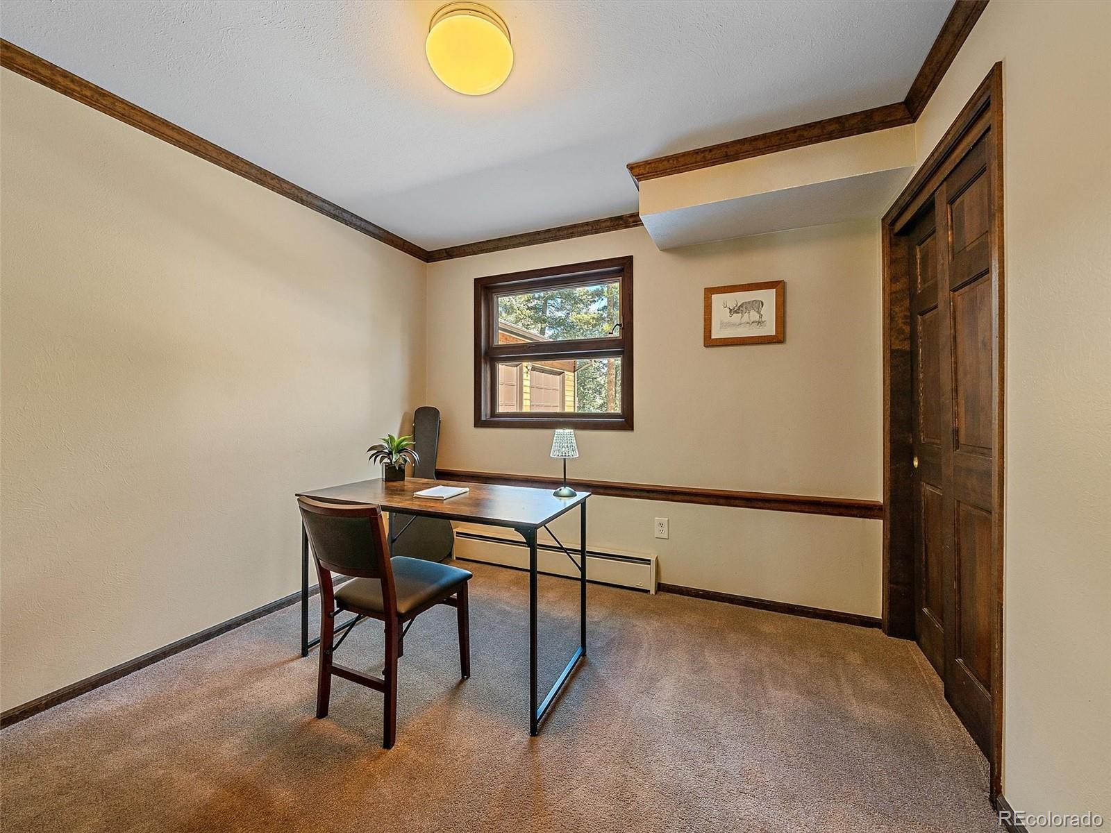 7990 Tim Tam Trail Evergreen, CO 80439 - Photo 18 of 45 a view of a workspace with furniture