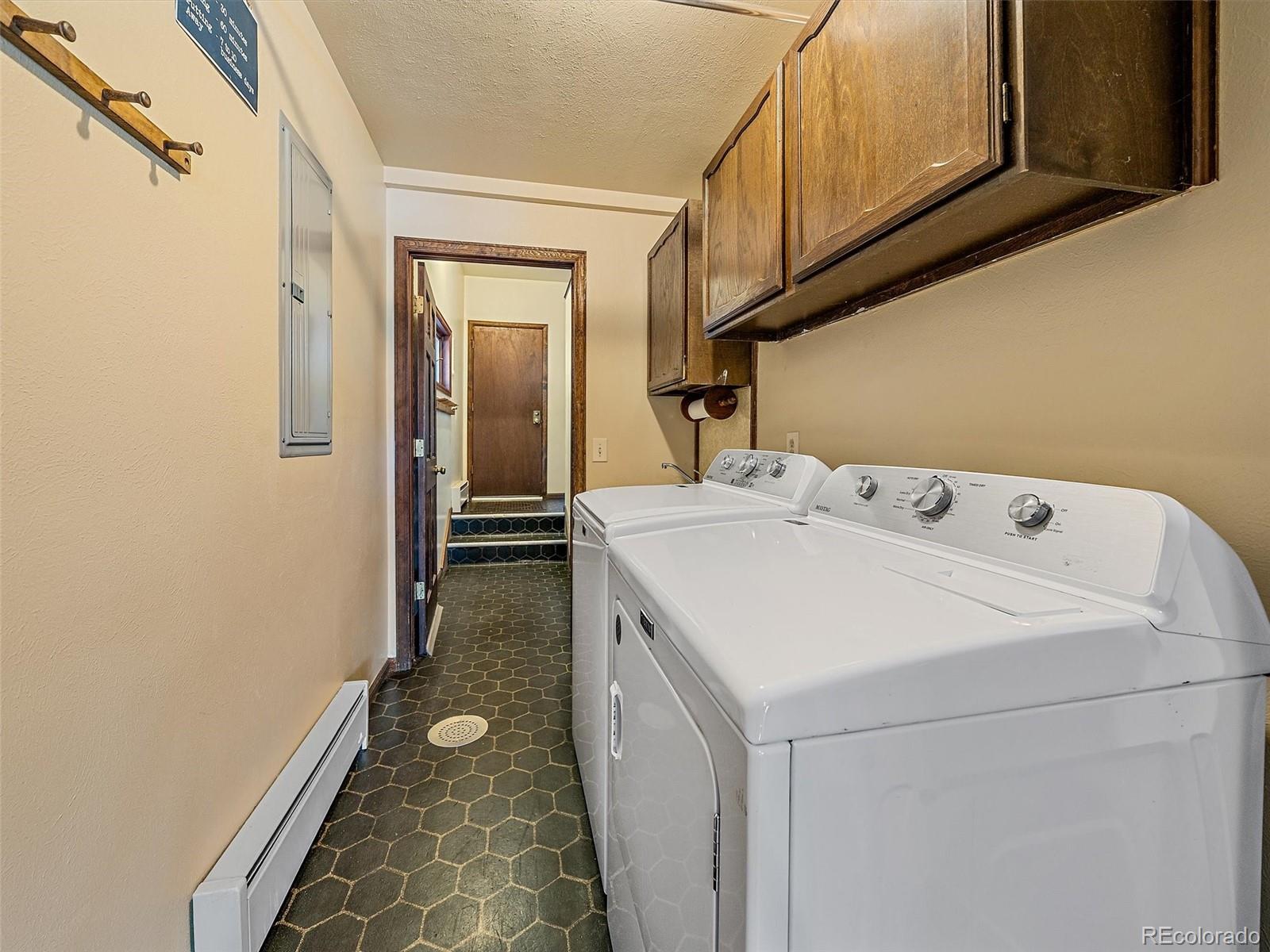 7990 Tim Tam Trail Evergreen, CO 80439 - Photo 19 of 45 a utility room with dryer and washer