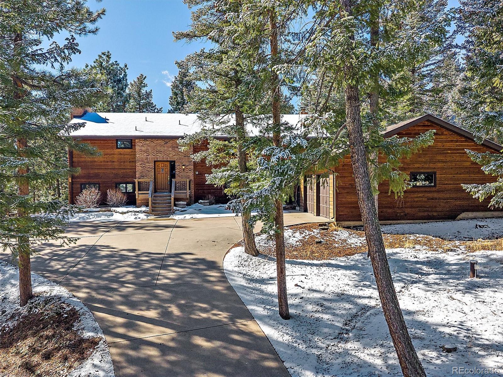 7990 Tim Tam Trail Evergreen, CO 80439 - Photo 2 of 45 a view of a house with snow on the road