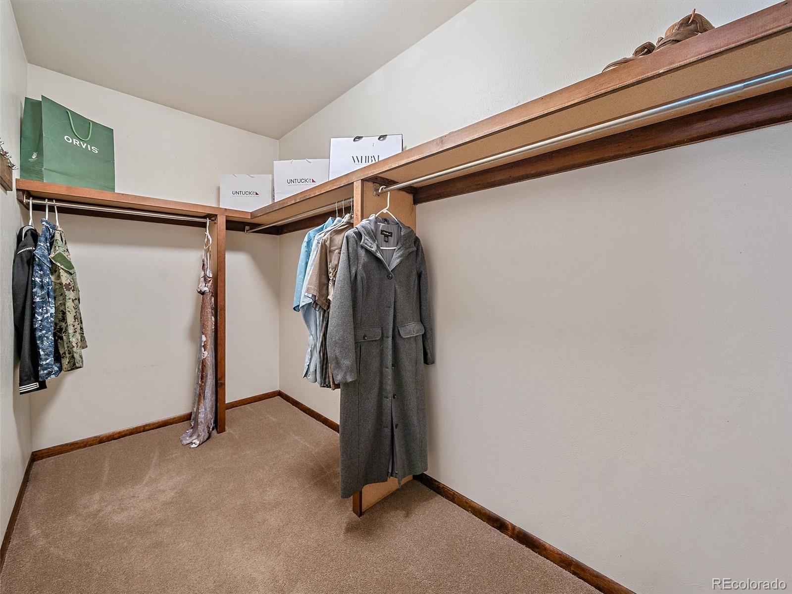 7990 Tim Tam Trail Evergreen, CO 80439 - Photo 24 of 45 a view of walk in closet with clothes and shoes