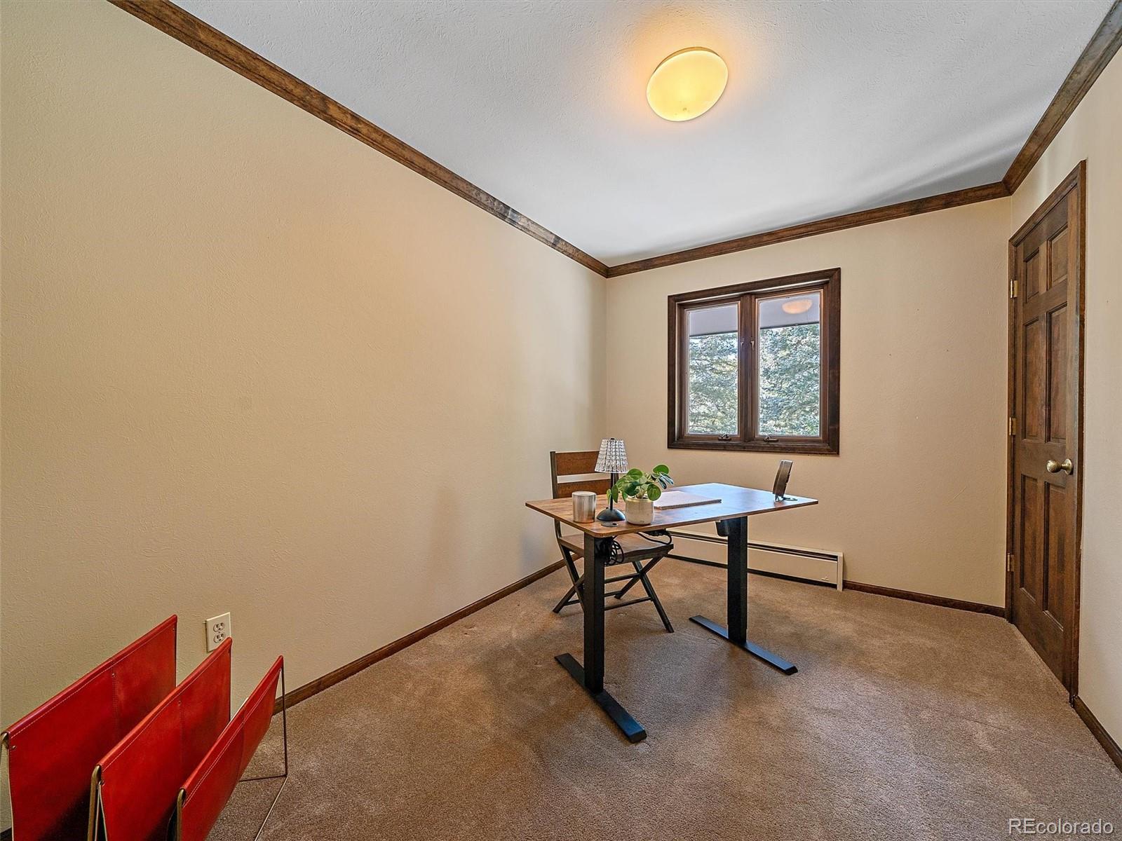 7990 Tim Tam Trail Evergreen, CO 80439 - Photo 32 of 45 a view of a workspace with furniture and a window