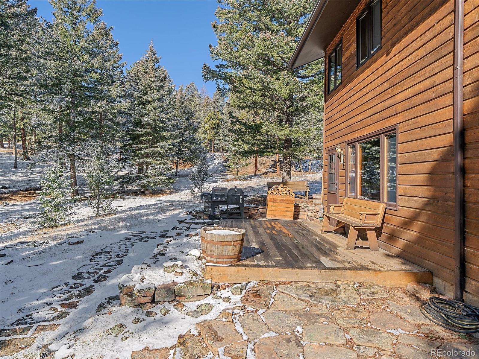7990 Tim Tam Trail Evergreen, CO 80439 - Photo 34 of 45 a front view of a house with a yard