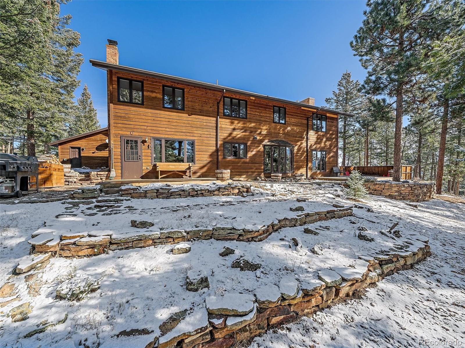 7990 Tim Tam Trail Evergreen, CO 80439 - Photo 39 of 45 a front view of a house with a yard