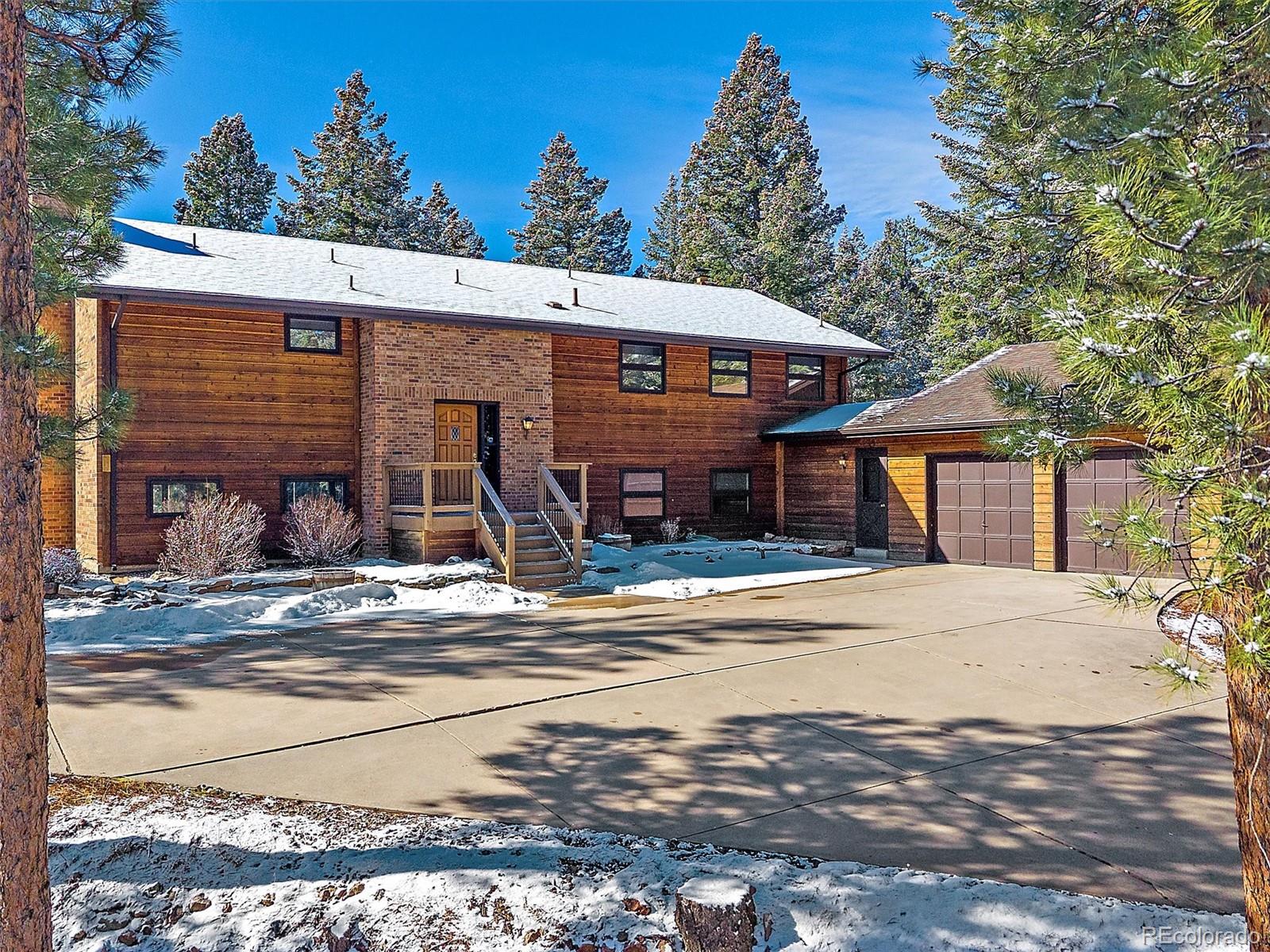 7990 Tim Tam Trail Evergreen, CO 80439 - Photo 43 of 45 a front view of a house with a yard