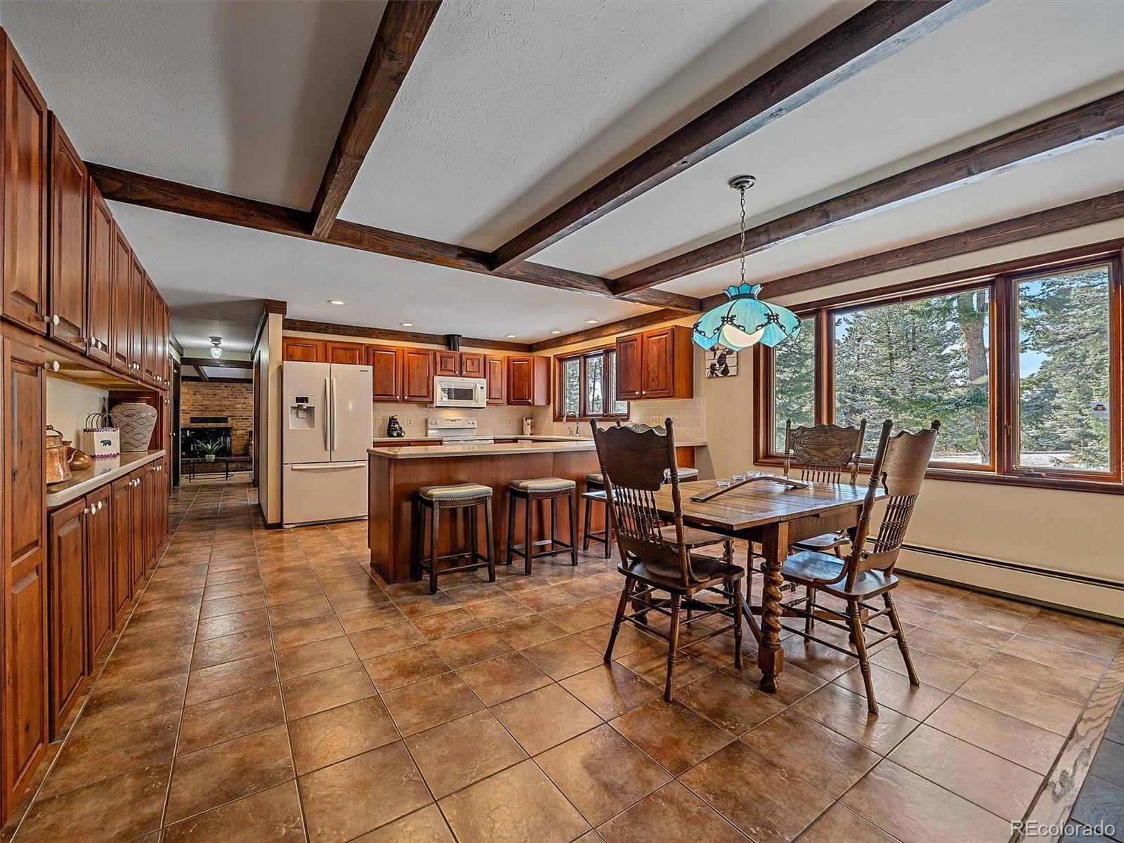 7990 Tim Tam Trail Evergreen, CO 80439 - Photo 5 of 45 a view of a dining area with furniture window and outside view
