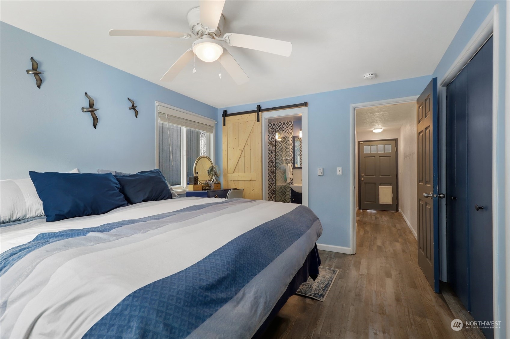 10351 Northeast North Shore Road Belfair, WA 98528 - Photo 16 of 40 a spacious bedroom with a bed and a chandelier