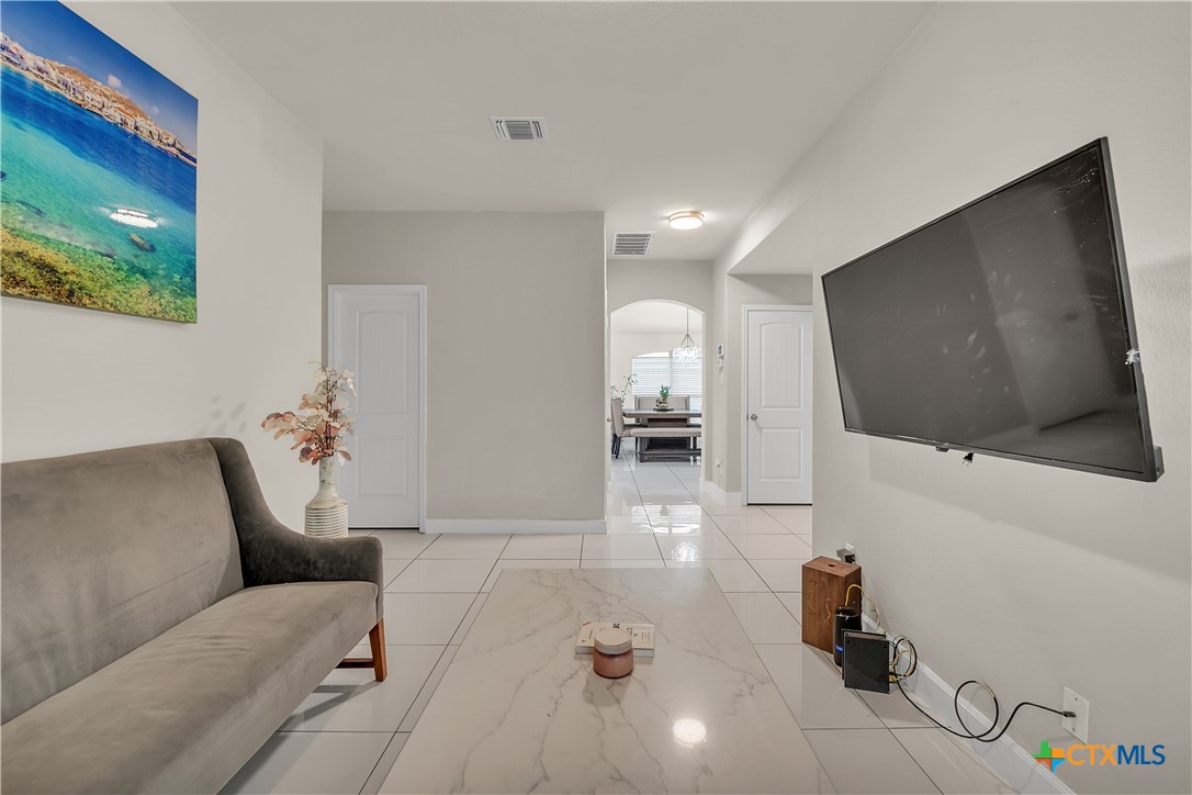 5577 Perdita Drive Belton, TX 76513 - Photo 20 of 25 a hallway with a couch and a flat screen tv