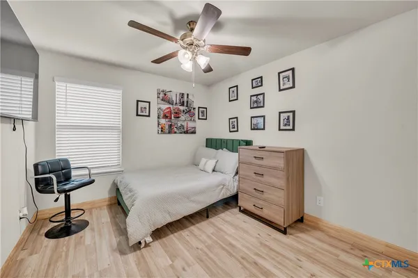 a bedroom with a bed and a chandelier