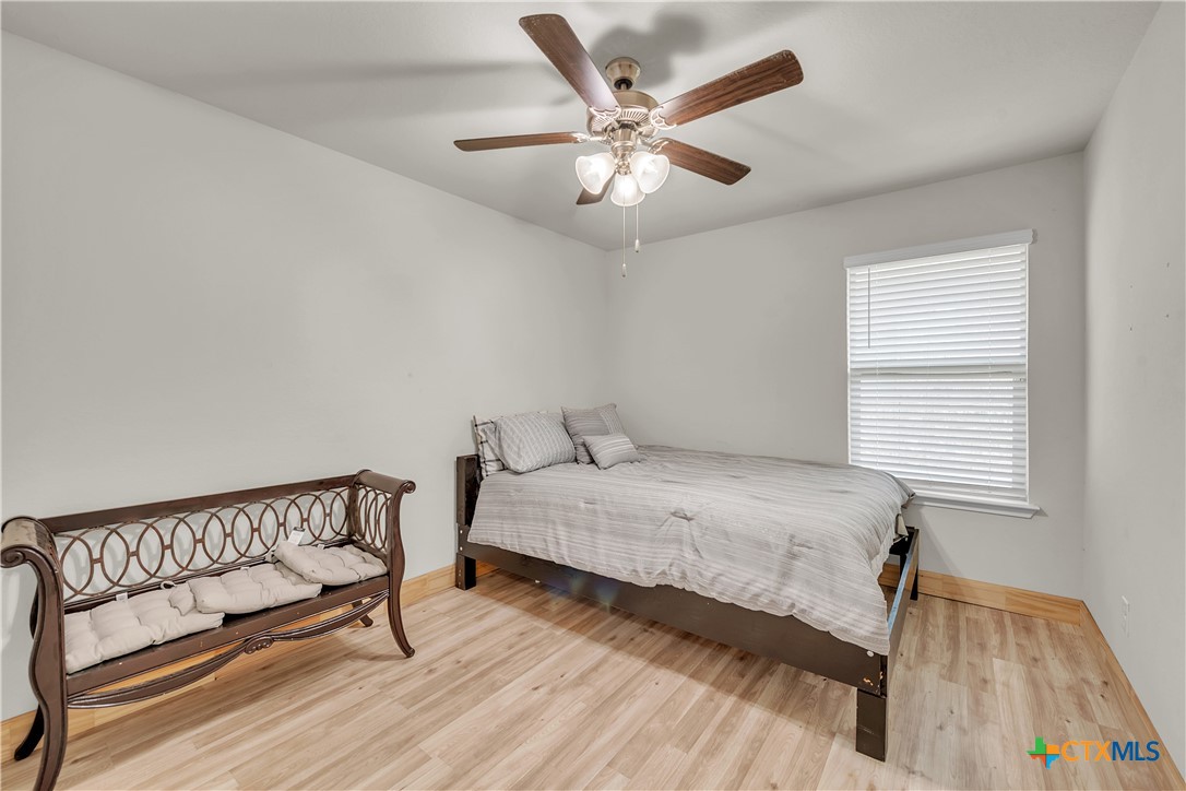 5577 Perdita Drive Belton, TX 76513 - Photo 22 of 25 a bedroom with a bed and a chandelier