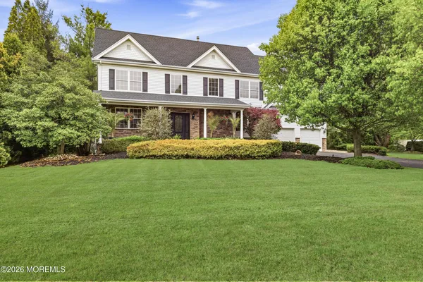a front view of a house with a garden