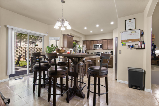 2005 Redtail Way Layton, UT 84040 - Photo 14 of 37 Open-concept kitchen and dining area featuring tile flooring and sliding glass door access to the backyard