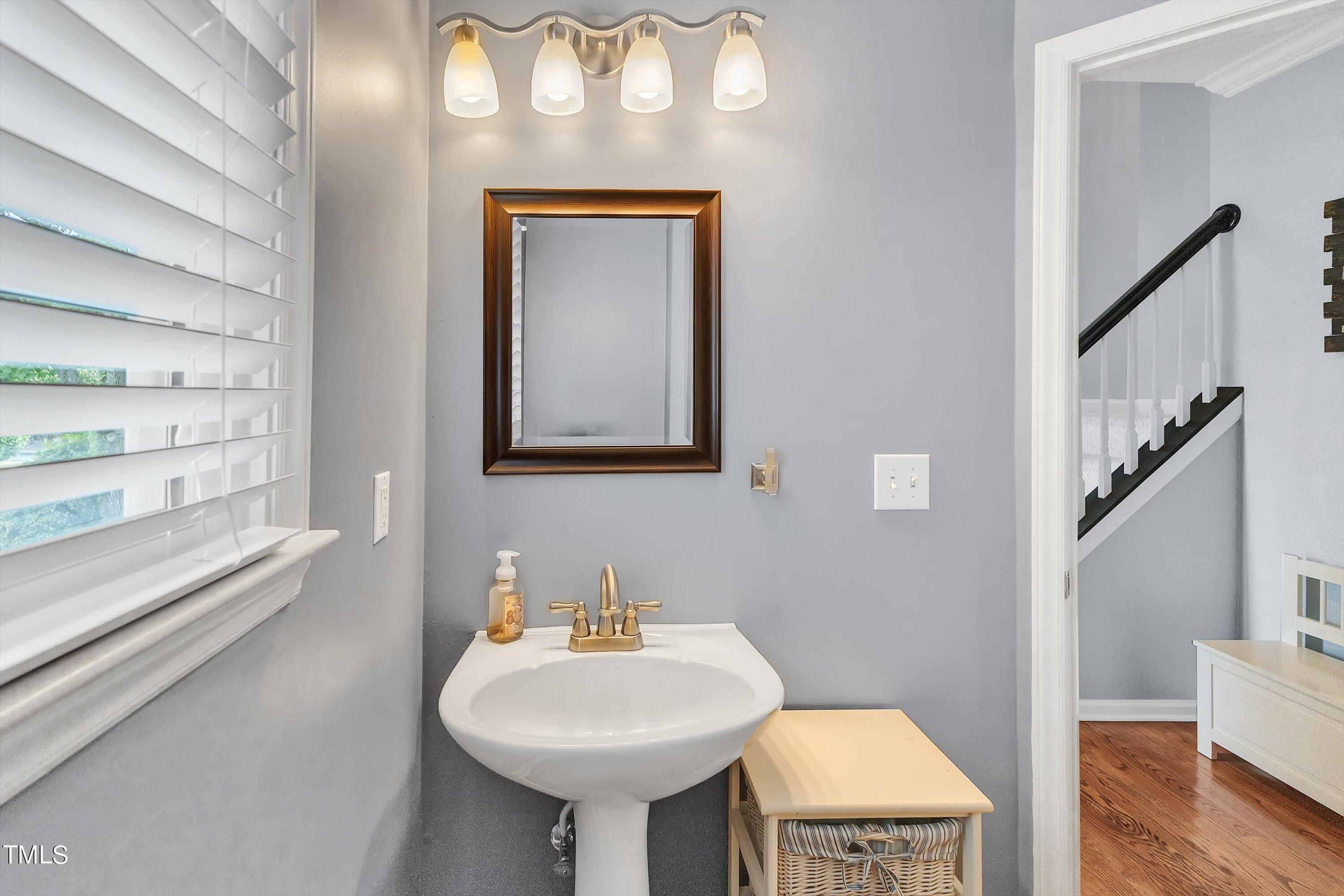 2424 Havershire Drive Raleigh, NC 27613 - Photo 11 of 52 a bathroom with a sink a mirror and a toilet