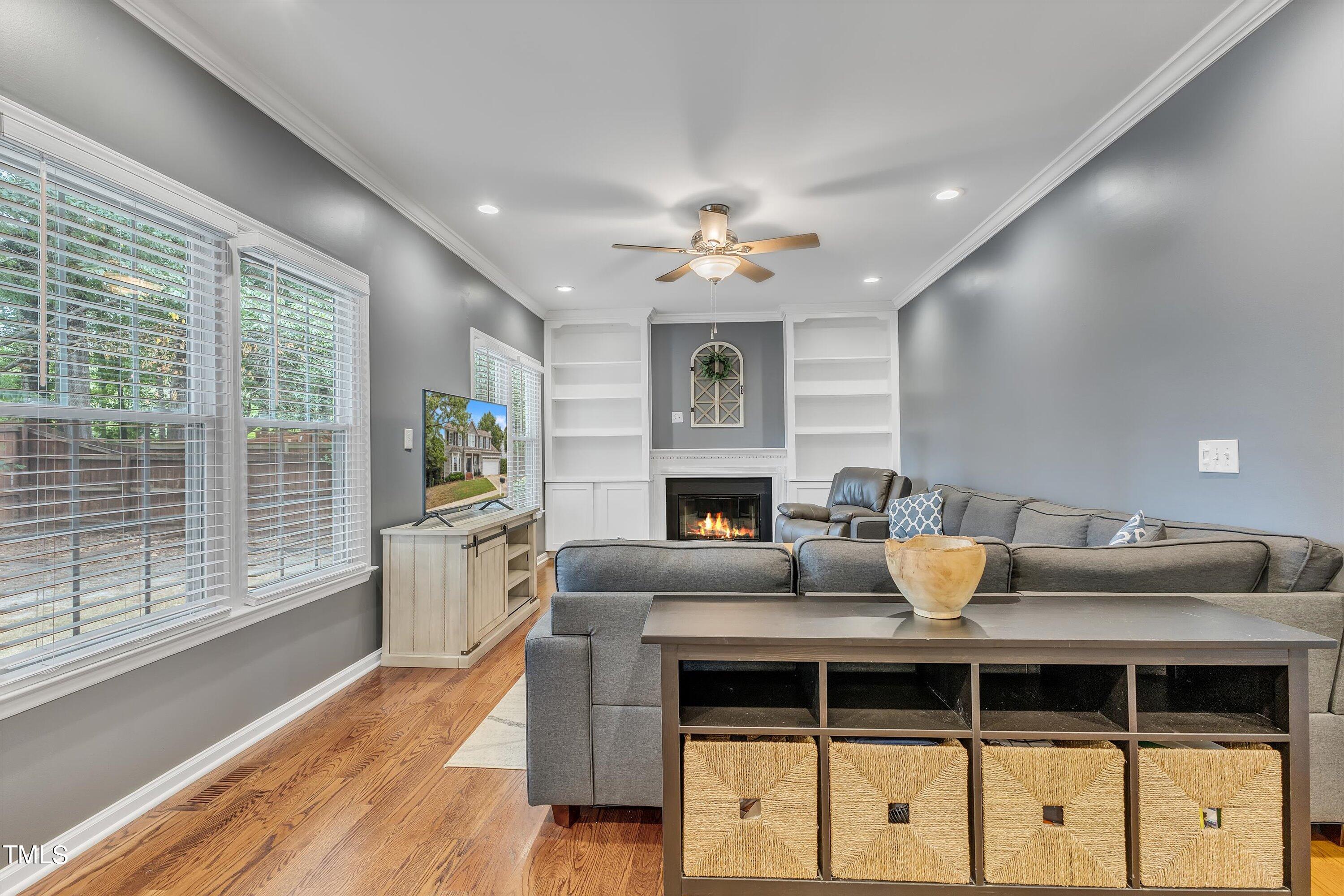 2424 Havershire Drive Raleigh, NC 27613 - Photo 18 of 52 a view of a dining room with furniture a fireplace and wooden floor