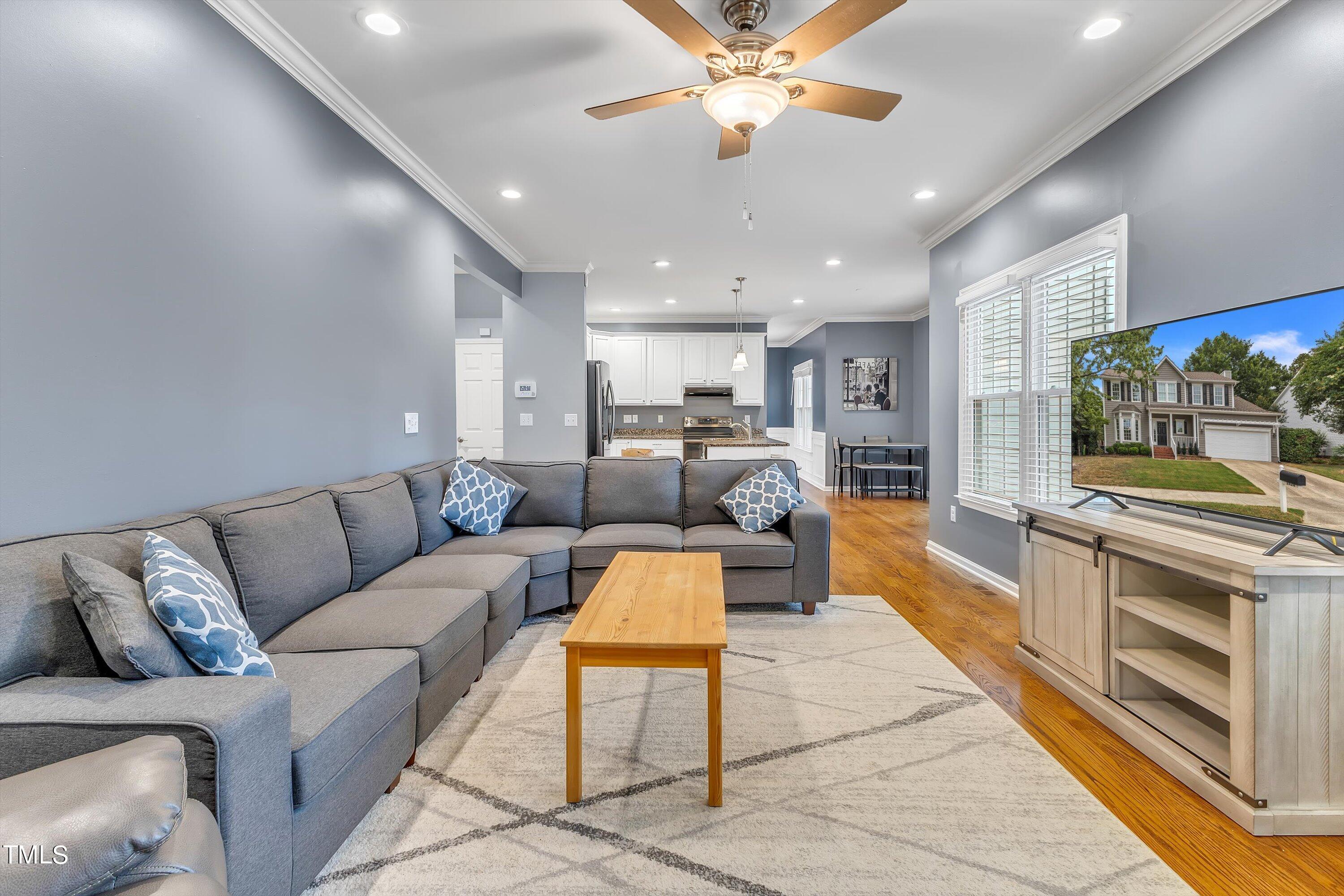 2424 Havershire Drive Raleigh, NC 27613 - Photo 21 of 52 a living room with furniture and a flat screen tv