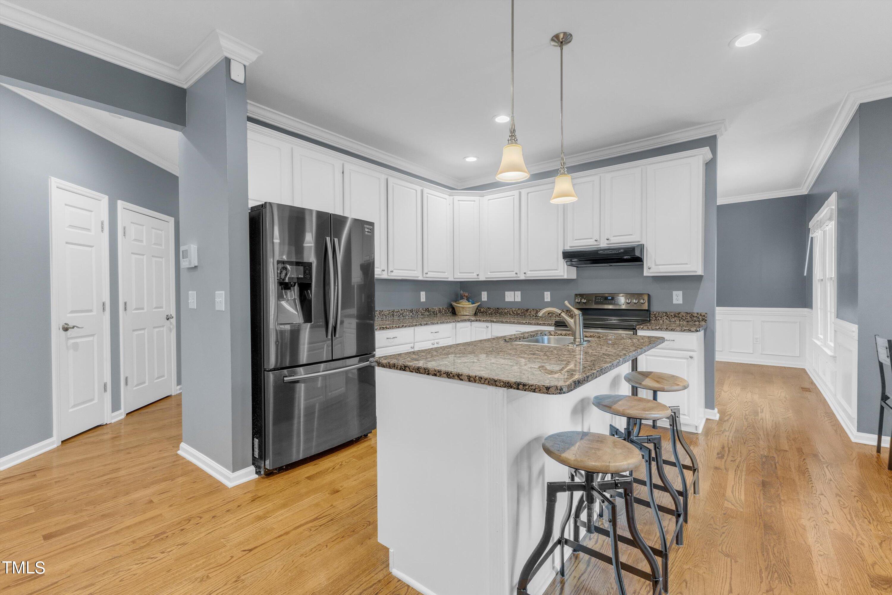 2424 Havershire Drive Raleigh, NC 27613 - Photo 23 of 52 a kitchen with stainless steel appliances granite countertop a refrigerator and a stove top oven