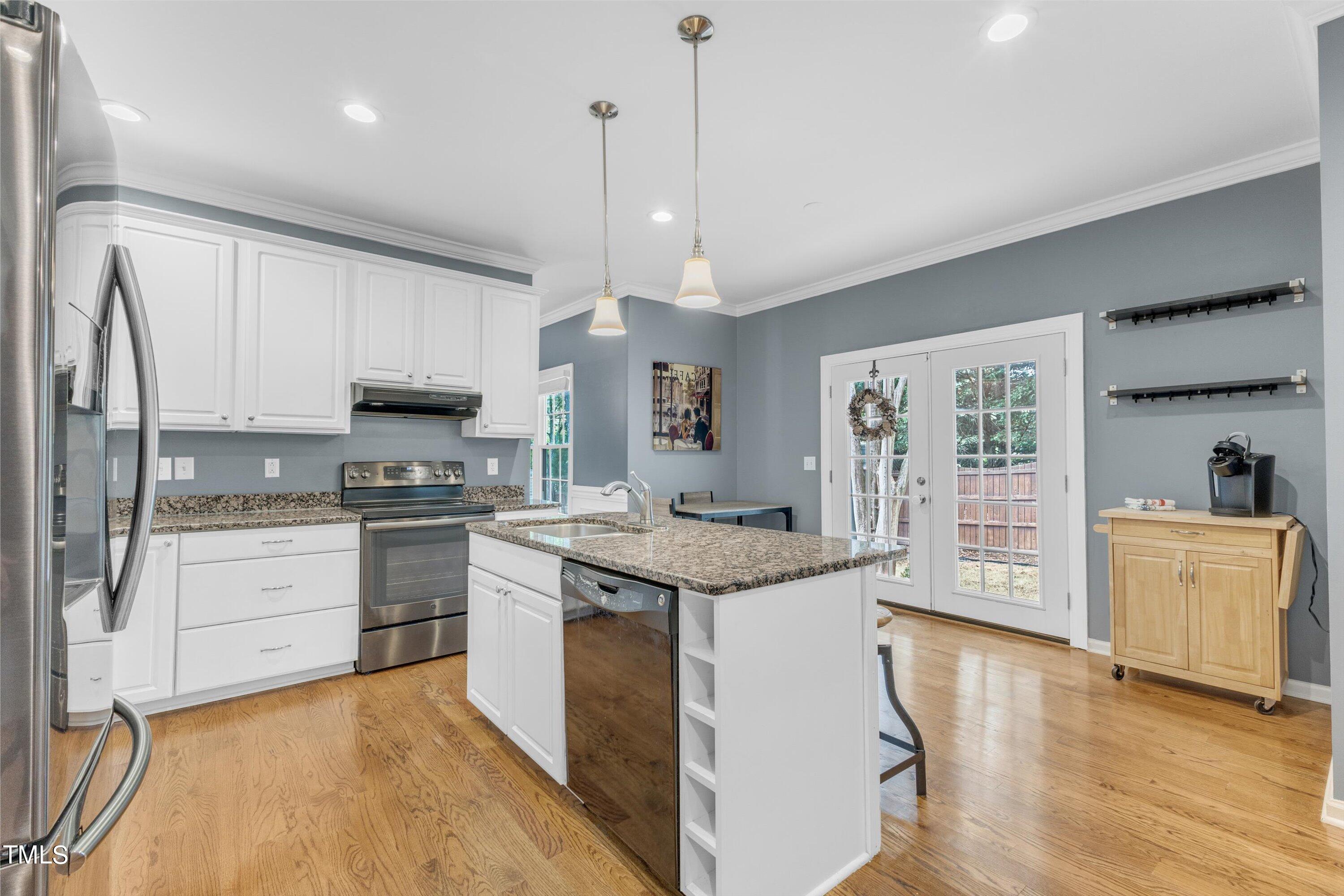 2424 Havershire Drive Raleigh, NC 27613 - Photo 24 of 52 a kitchen with granite countertop white cabinets and white appliances