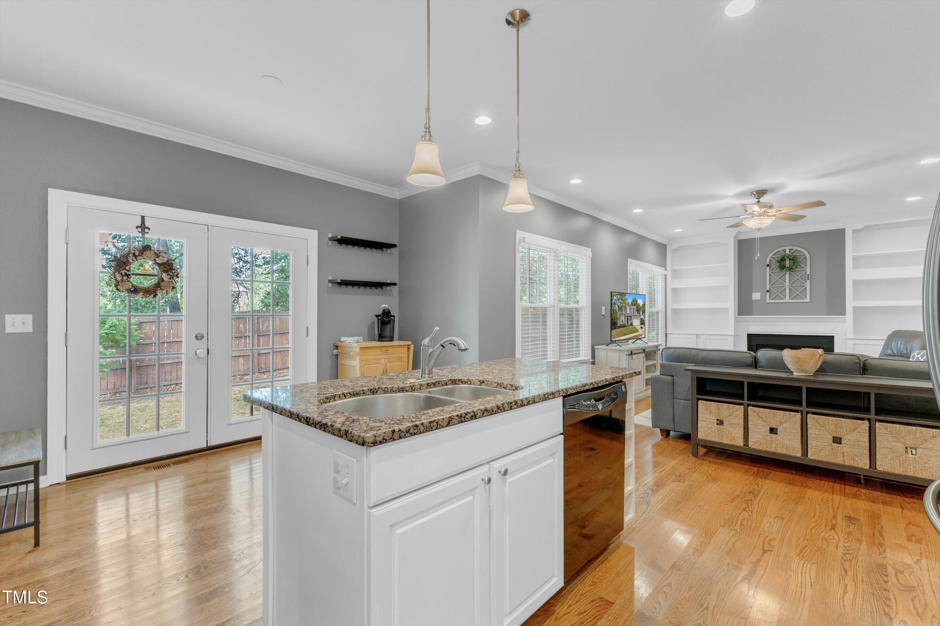 2424 Havershire Drive Raleigh, NC 27613 - Photo 25 of 52 a open kitchen with stainless steel appliances granite countertop a stove and a wooden floors