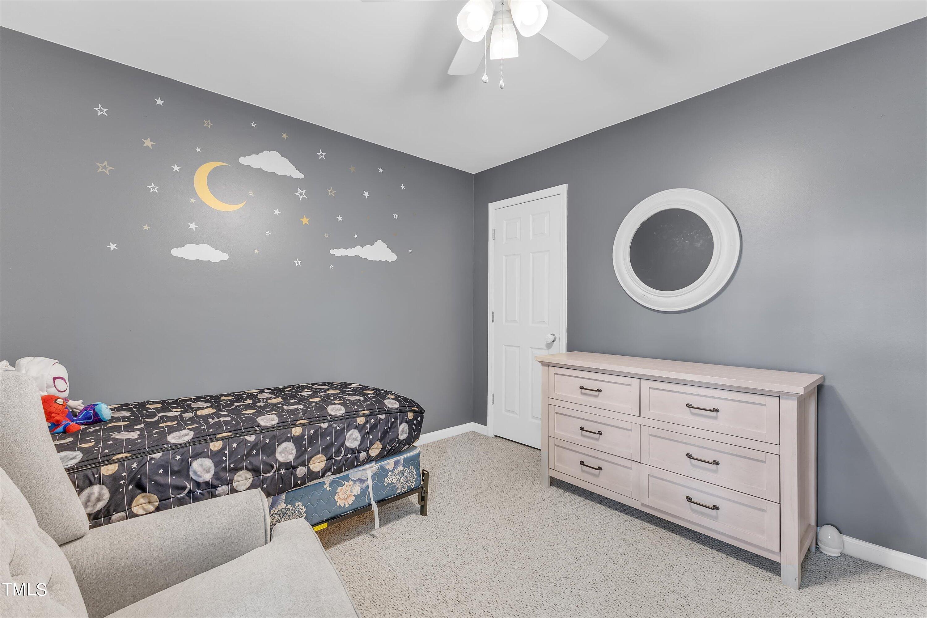 2424 Havershire Drive Raleigh, NC 27613 - Photo 43 of 52 a bedroom with a bed and a chandelier