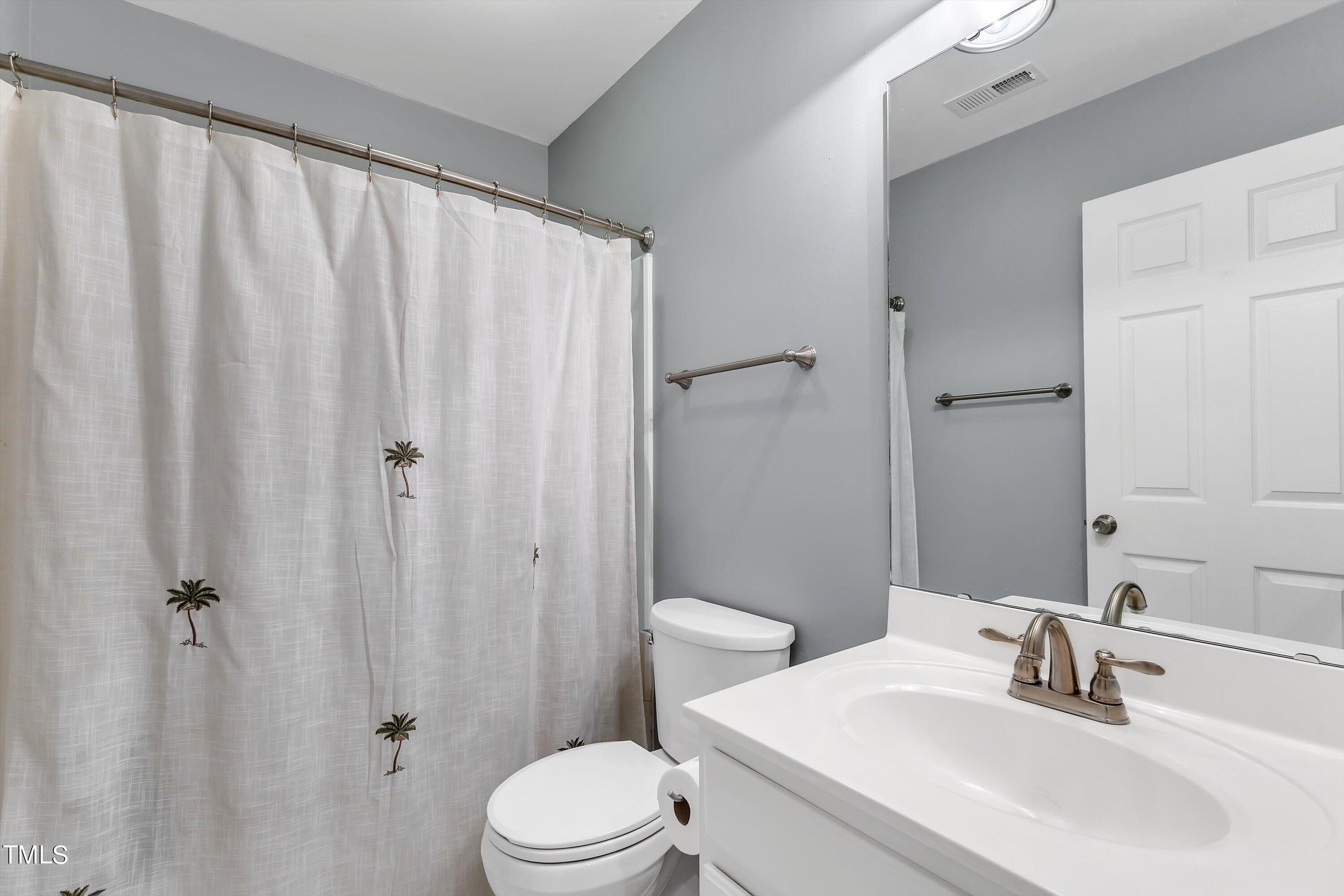 2424 Havershire Drive Raleigh, NC 27613 - Photo 44 of 52 a bathroom with a sink a toilet and shower