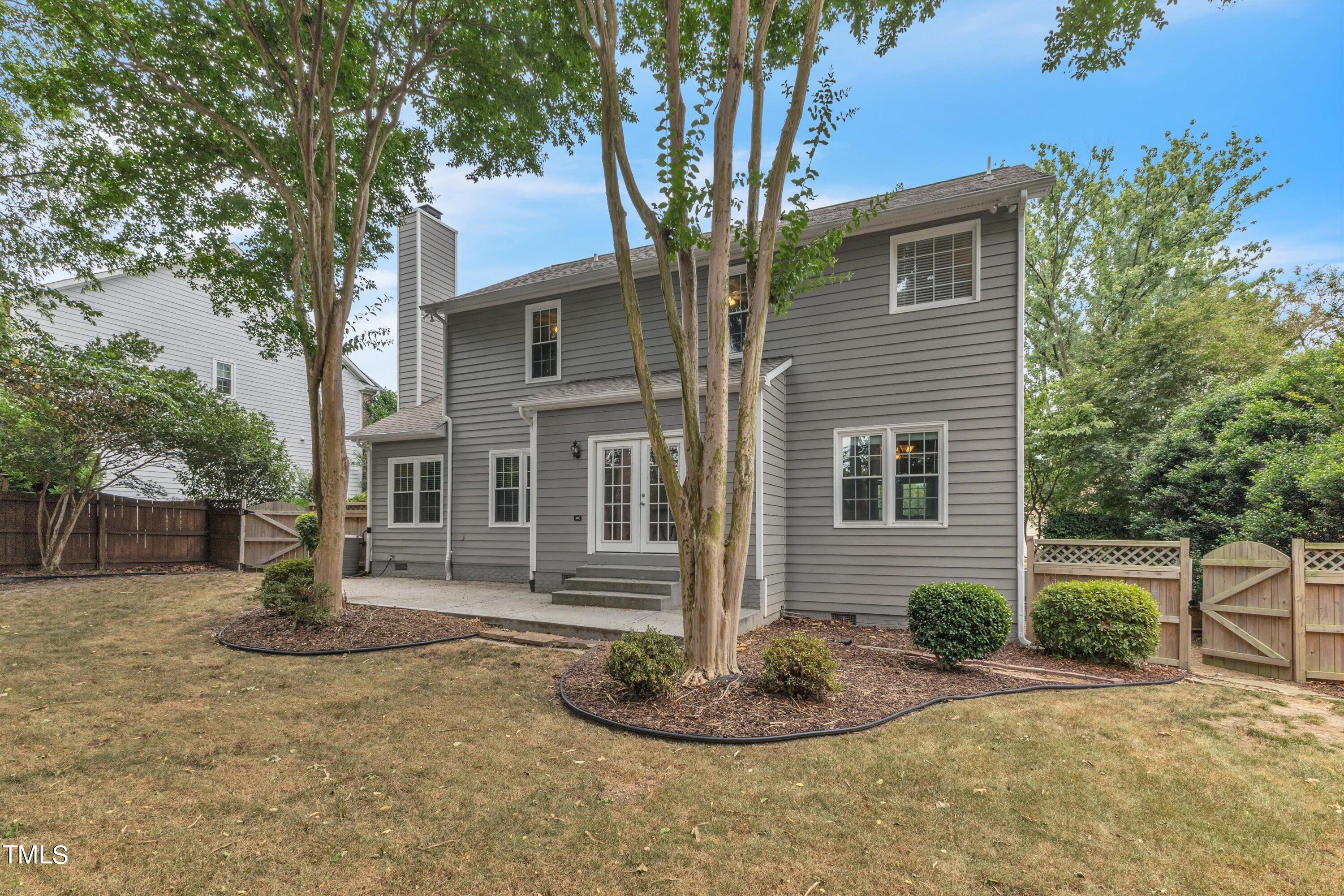 2424 Havershire Drive Raleigh, NC 27613 - Photo 50 of 52 a backyard of a house with potted plants and large tree