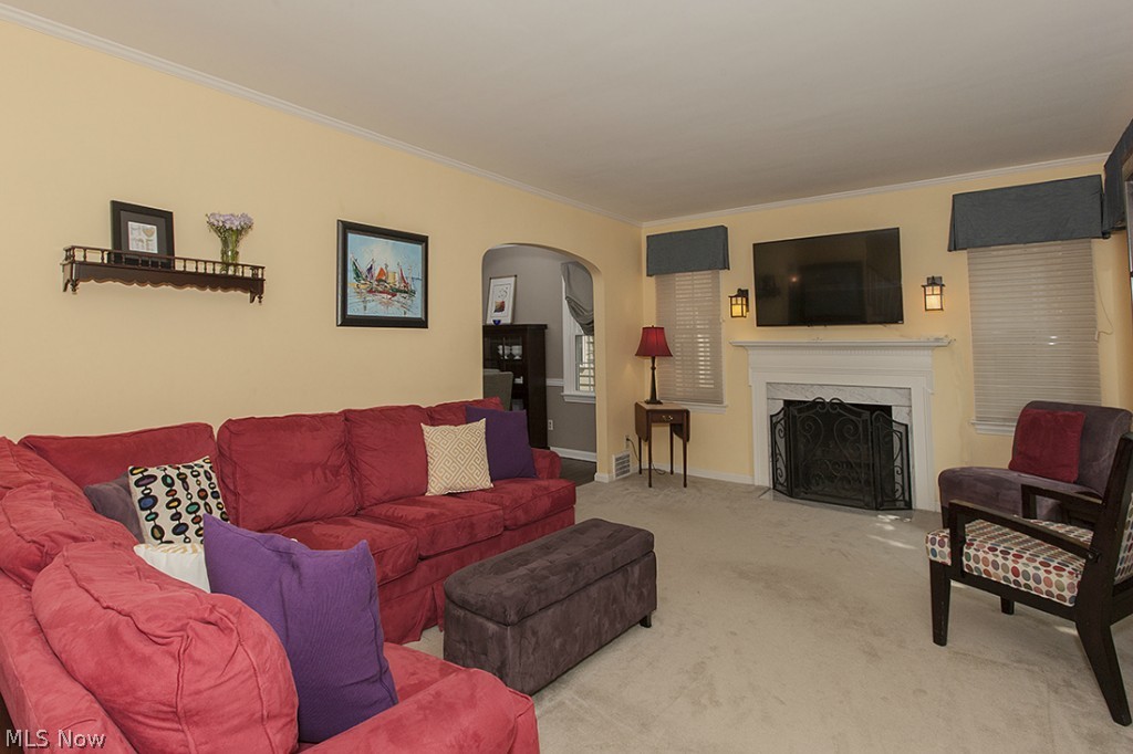 2478 Fenwick Road Cleveland, OH 44118 - Photo 3 of 22 A wood buring fireplace and architectural detail add to the ambiance of the living room.