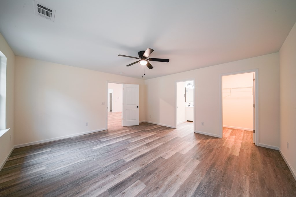 1050 Mt Airy Road Waverly Hall, GA 31831 - Photo 15 of 31 an empty room with wooden floor and ceiling fan