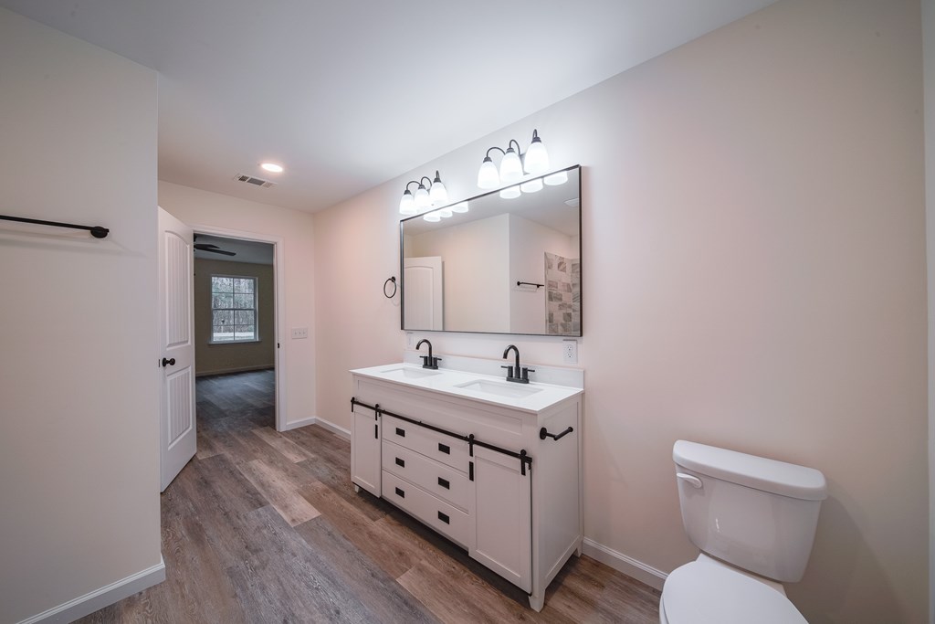 1050 Mt Airy Road Waverly Hall, GA 31831 - Photo 20 of 31 a bathroom with a toilet sink and mirror