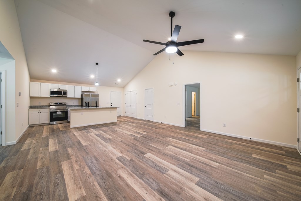 1050 Mt Airy Road Waverly Hall, GA 31831 - Photo 7 of 31 a view of a kitchen with a stove cabinets and wooden floor